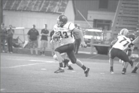 Shiner junior Chad Neubauer runs the ball into the end zone for the first touchdown of the game Friday night at Industrial. The Comanches defeated the Cobras 27-0.