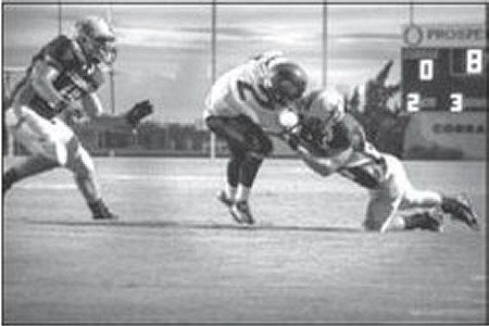 Industrial senior Jeffrey Koch takes down Shiner senior Tyler Patek just outside the end zone Friday night at Industrial.